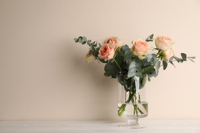 Vase with bouquet of beautiful roses on white wooden table. Space for text Photo of Vase with bouquet of beautiful roses on white wooden table. Space for text