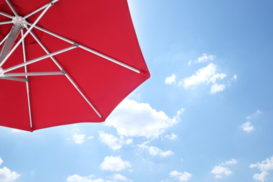 View of red umbrella and blue sky on sunny day Photo of View of red umbrella and blue sky on sunny day