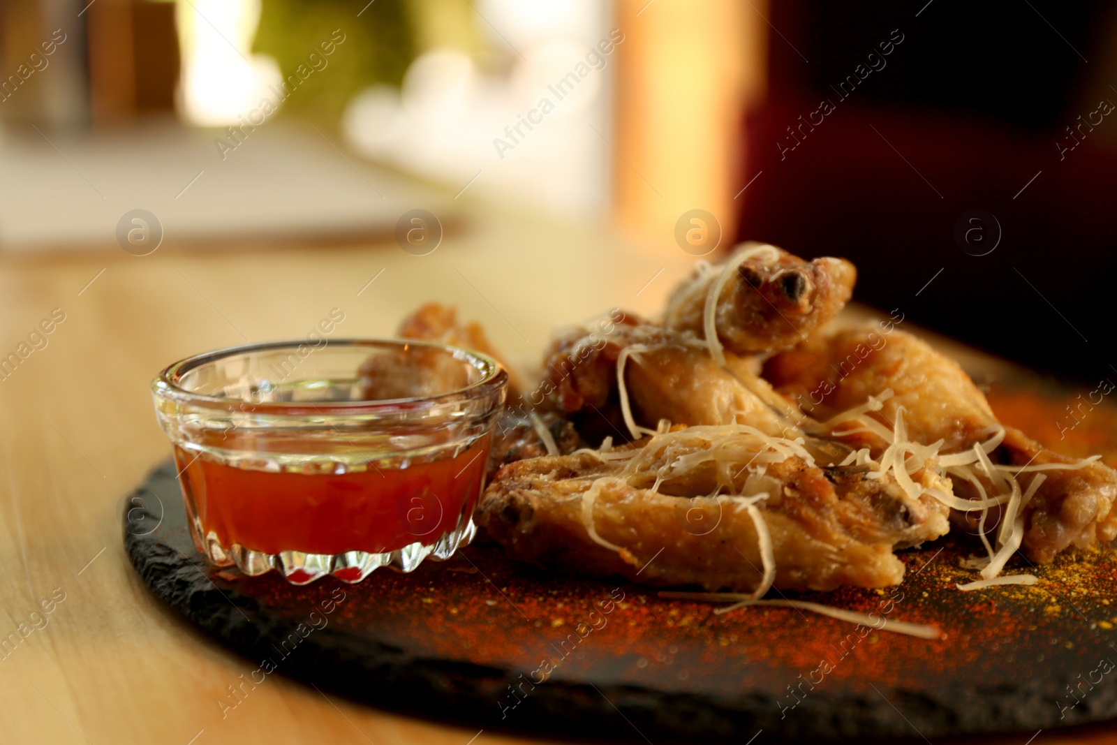 Tasty BBQ wings served on table in cafe Photo of Tasty BBQ wings served on table in cafe
