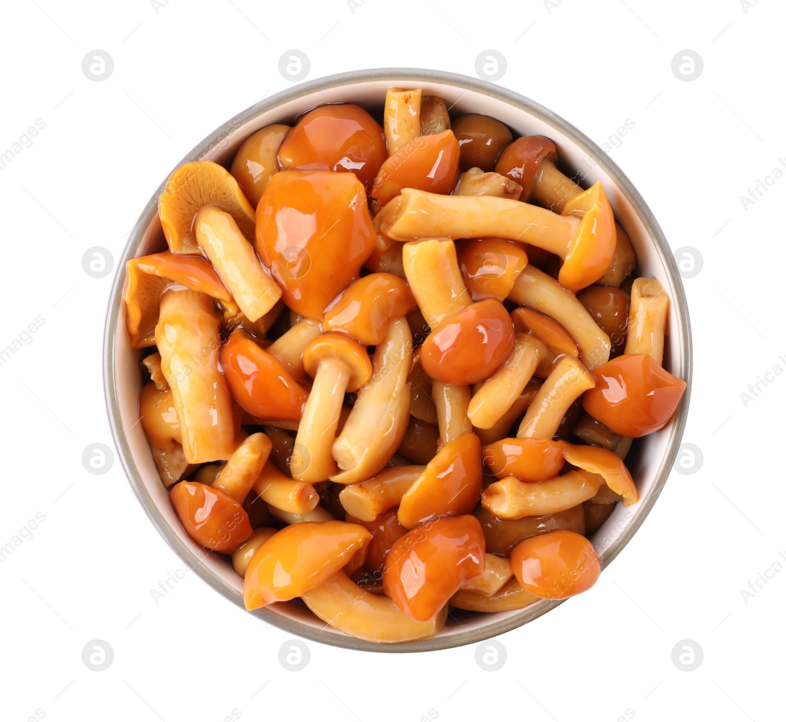 Photo of Tasty marinated mushrooms in bowl isolated on white, top view