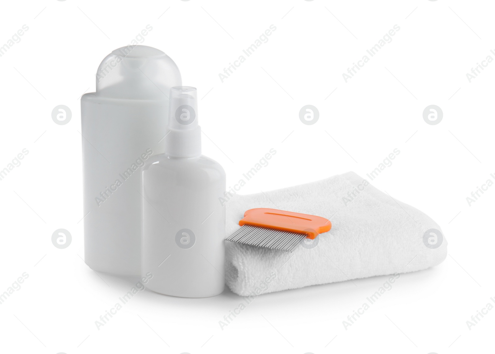 Products for anti lice treatment, metal comb and towel on white background Photo of Products for anti lice treatment, metal comb and towel on white background