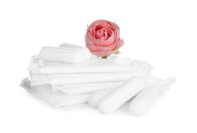 Tampons, disposable menstrual pads and beautiful rose on white background Photo of Tampons, disposable menstrual pads and beautiful rose on white background