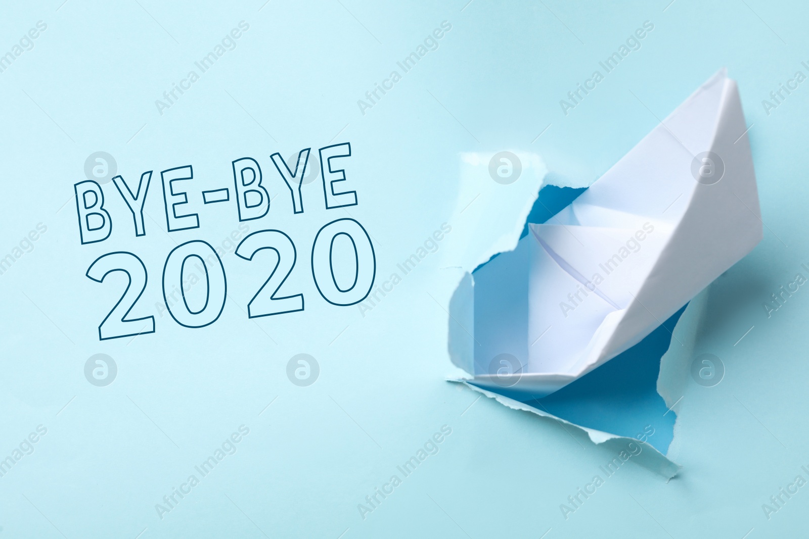 Bye-bye 2020. Torn paper with toy ship imitating sinking and ending of year Photo of Bye-bye 2020. Torn paper with toy ship imitating sinking and ending of year