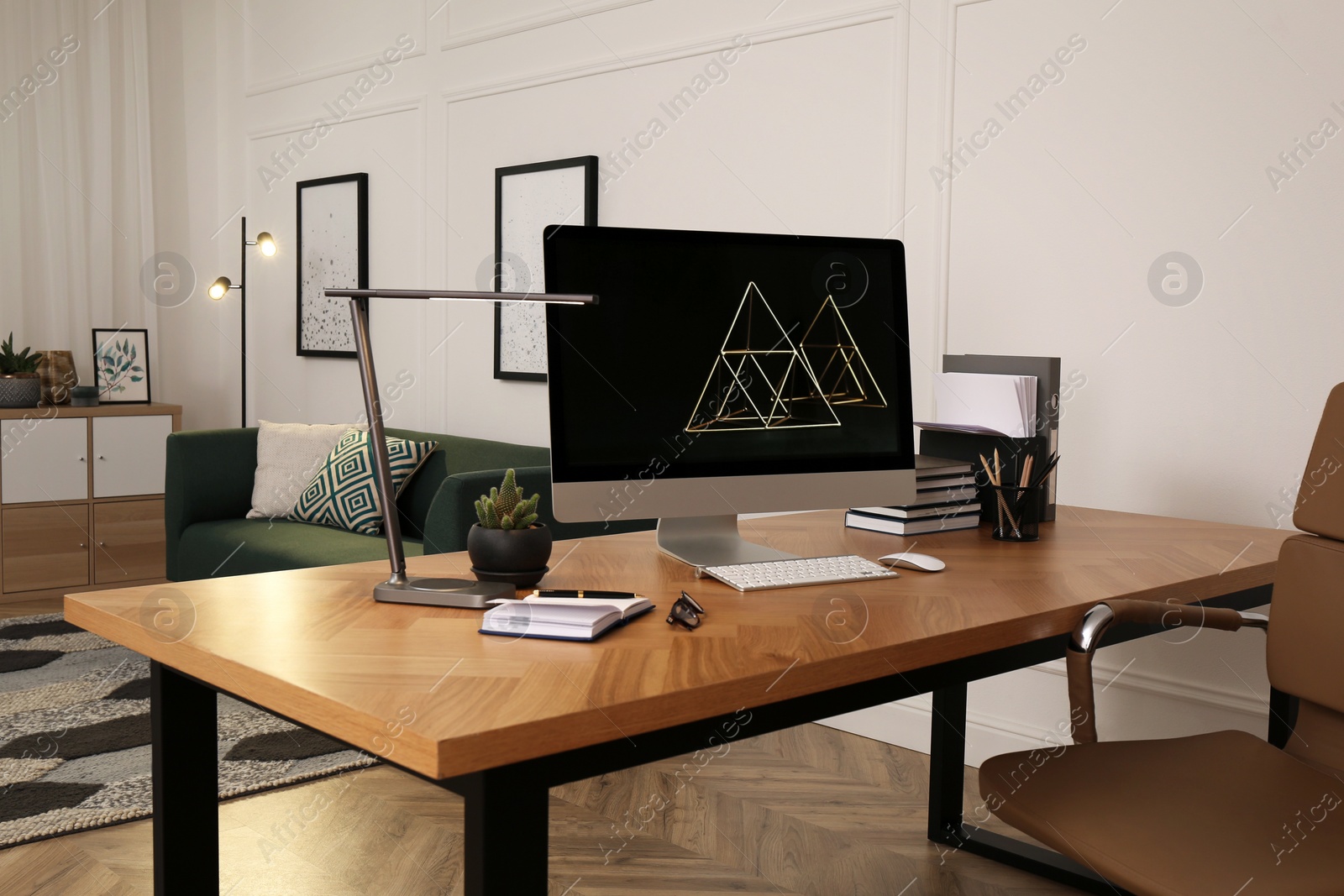 Workplace with computer on wooden desk in light room. Modern interior design Photo of Workplace with computer on wooden desk in light room. Modern interior design