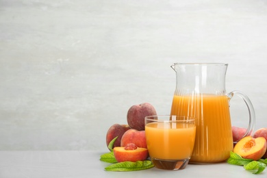 Natural freshly made peach juice on light table. Space for text Photo of Natural freshly made peach juice on light table. Space for text