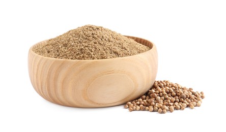 Wooden bowl with powdered coriander and corns on white background Photo of Wooden bowl with powdered coriander and corns on white background