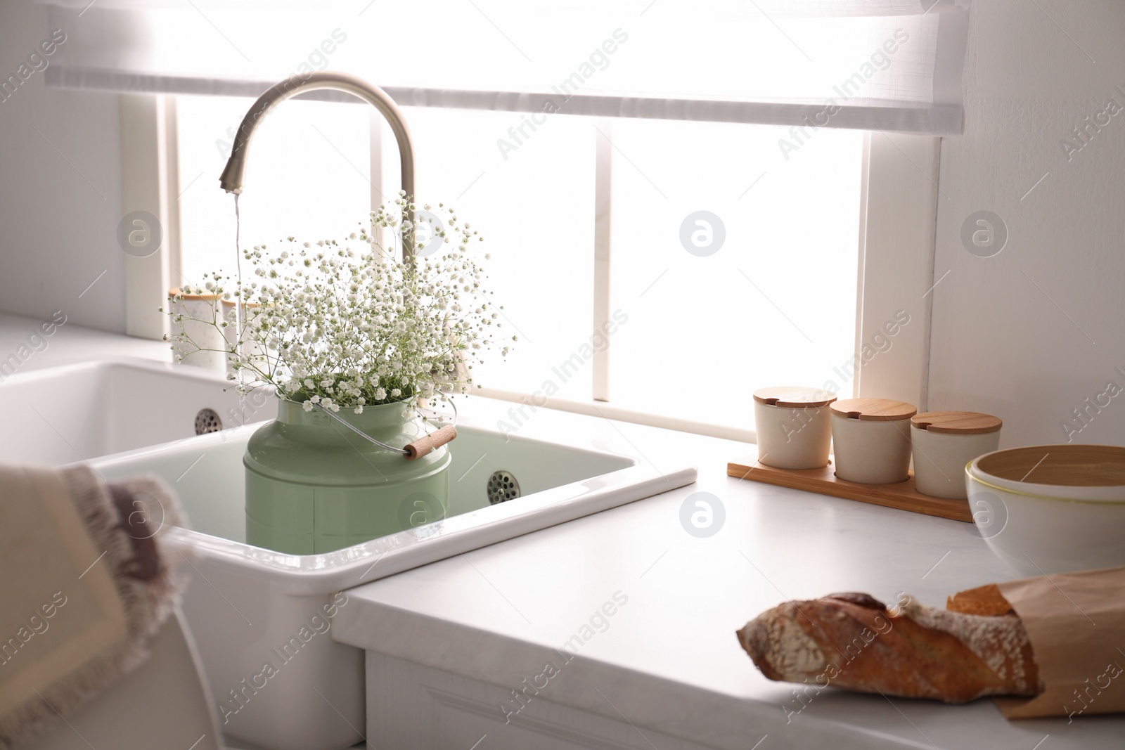 Bouquet of gypsophila flowers in sink. Kitchen interior design Photo of Bouquet of gypsophila flowers in sink. Kitchen interior design