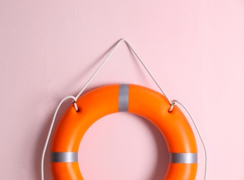 Orange lifebuoy on pink background. Rescue equipment Photo of Orange lifebuoy on pink background. Rescue equipment