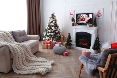 Stylish living room interior with TV set, Christmas tree and fireplace Image of Stylish living room interior with TV set, Christmas tree and fireplace