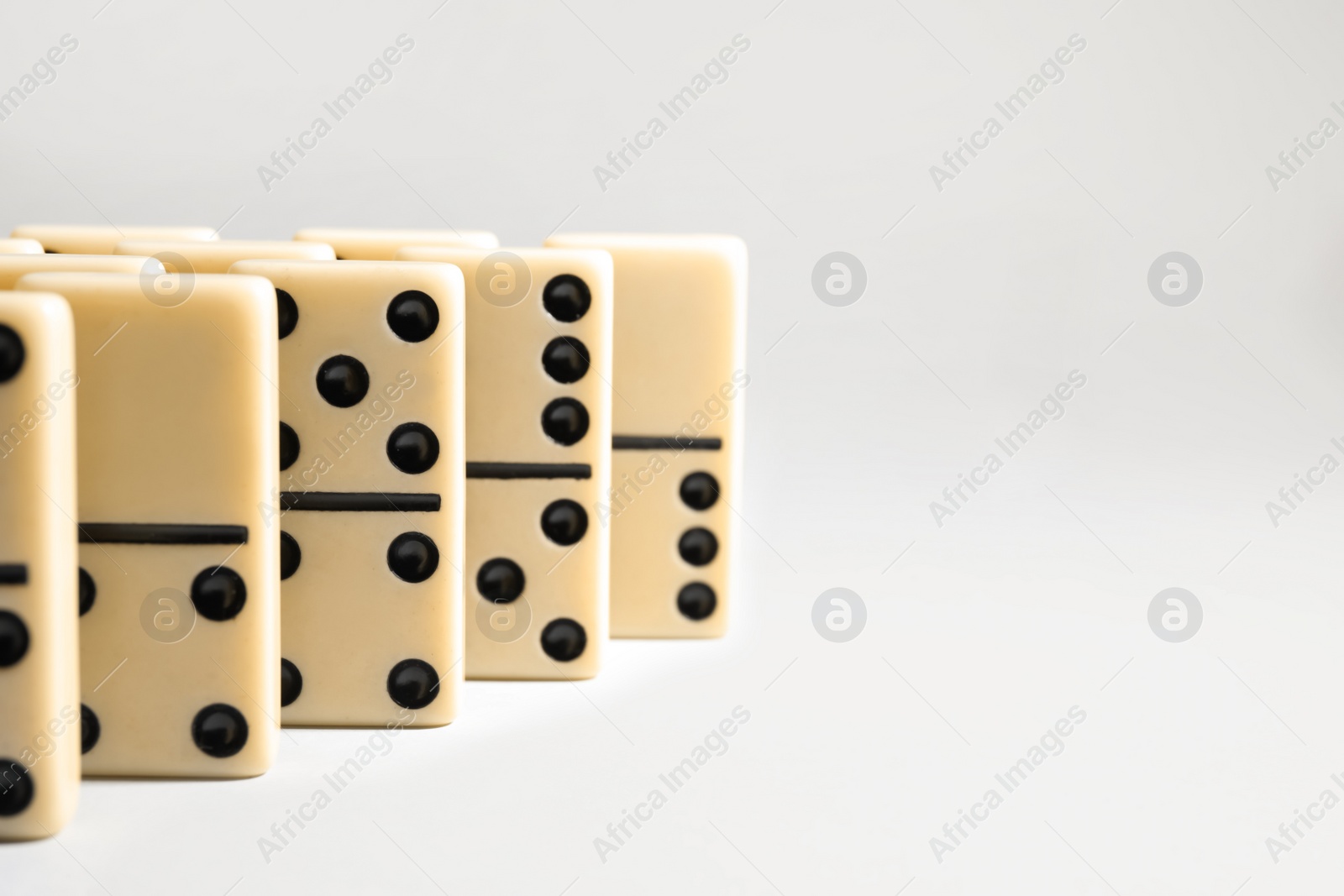 Domino tiles on white background. Space for text Photo of Domino tiles on white background. Space for text