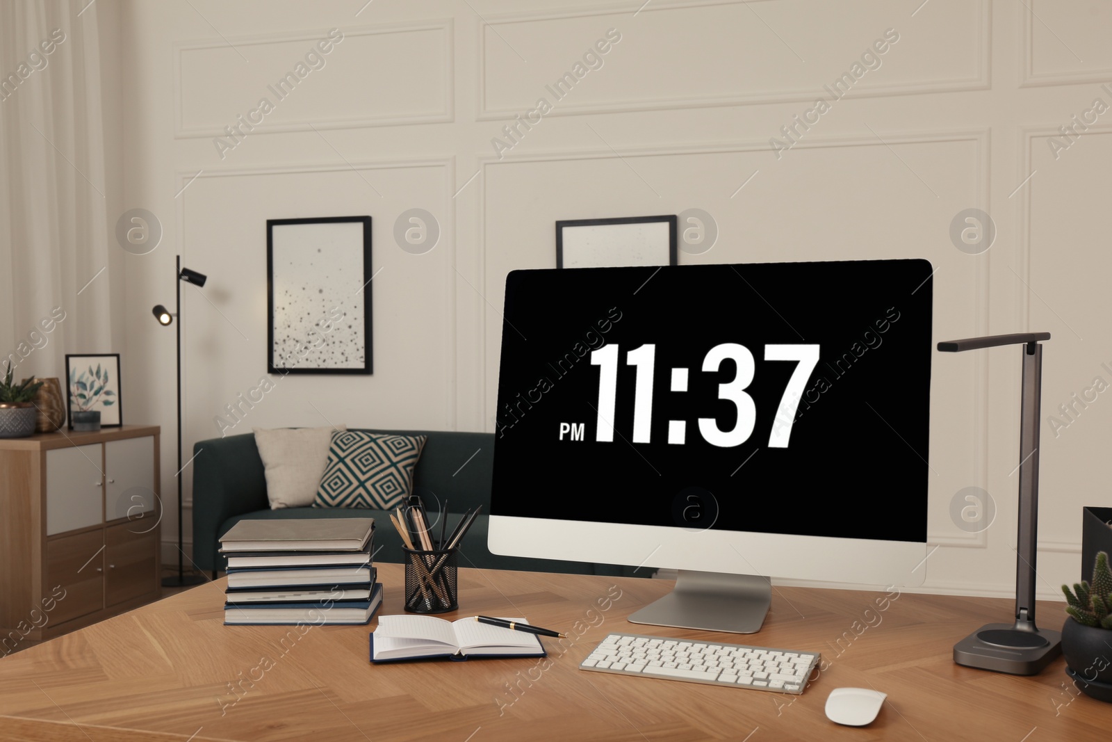 Comfortable workplace with modern computer on wooden desk in room. Interior design Photo of Comfortable workplace with modern computer on wooden desk in room. Interior design