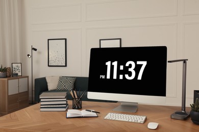 Comfortable workplace with modern computer on wooden desk in room. Interior design Photo of Comfortable workplace with modern computer on wooden desk in room. Interior design