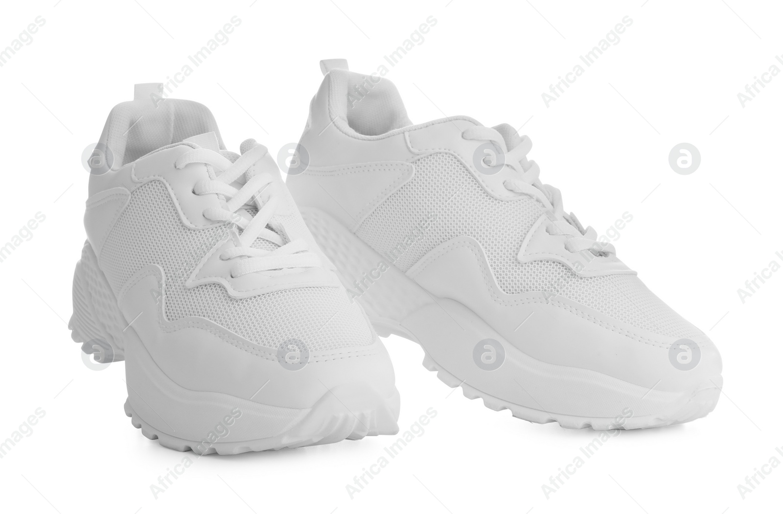 Photo of Stylish sneakers on white background. Trendy footwear