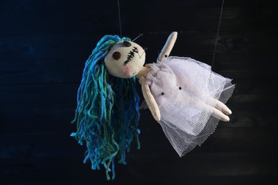 Female voodoo doll with pins on dark background Photo of Female voodoo doll with pins on dark background