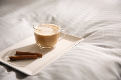 Tray with morning coffee on soft blanket. Space for text Photo of Tray with morning coffee on soft blanket. Space for text