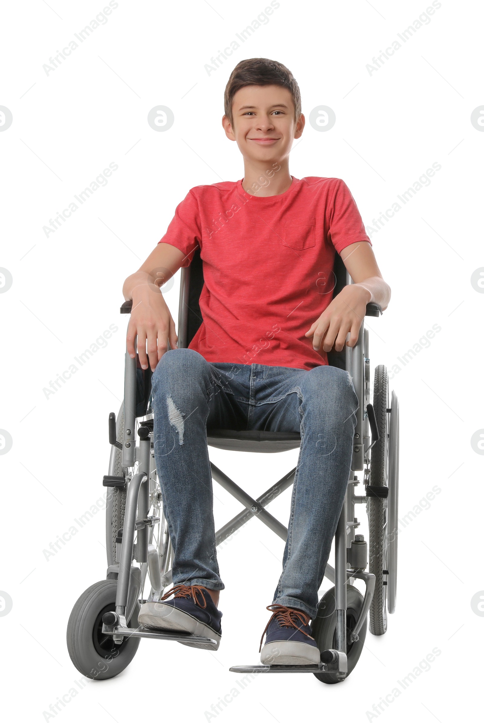 Teen boy in wheelchair on white background Photo of Teen boy in wheelchair on white background