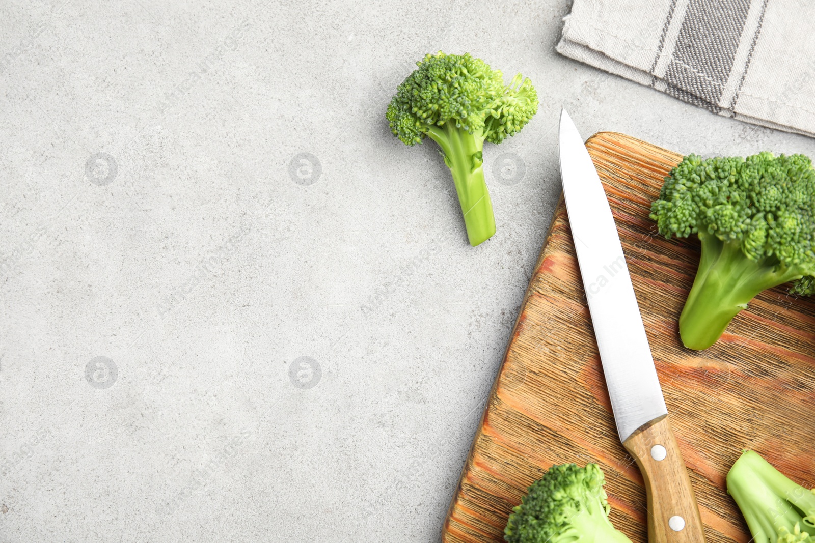Fresh green broccoli on light table, flat lay. Space for text Photo of Fresh green broccoli on light table, flat lay. Space for text