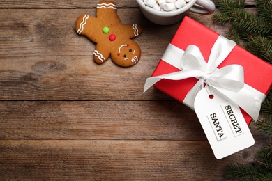 Photo of Flat lay composition with present from secret Santa on wooden table, space for text