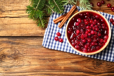 Flat lay composition with fresh cranberry sauce on wooden table, space for text Photo of Flat lay composition with fresh cranberry sauce on wooden table, space for text
