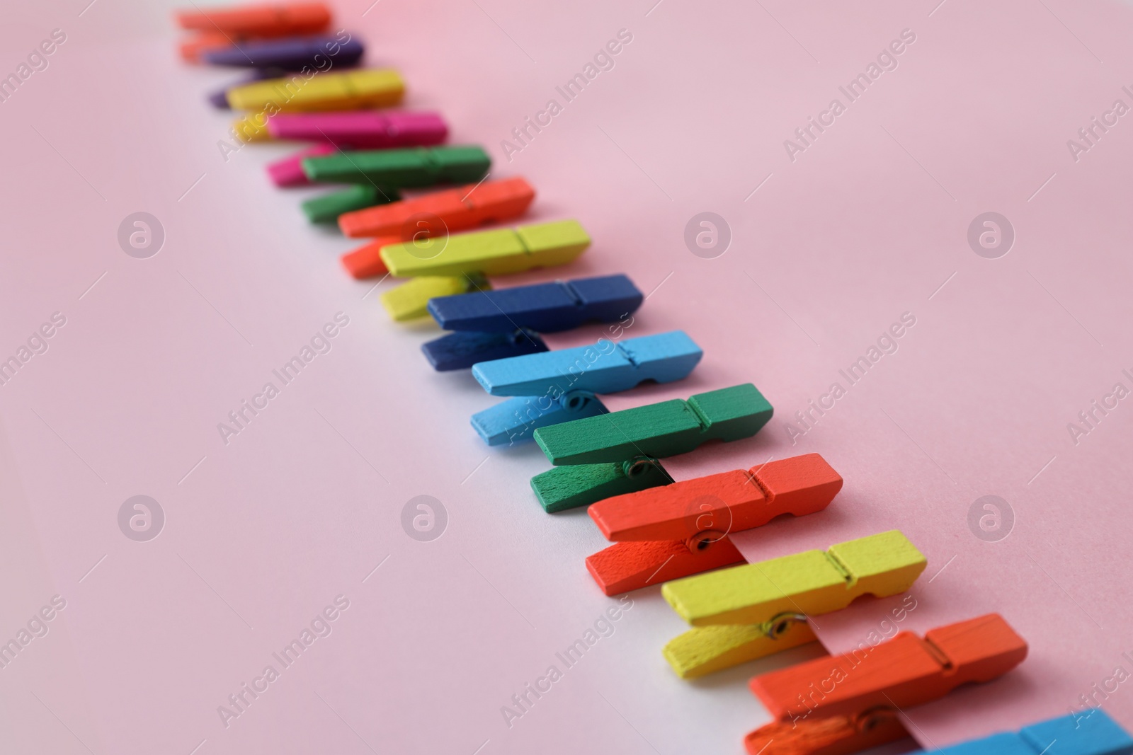 Many different colorful clothespins on pink background. Diversity concept Photo of Many different colorful clothespins on pink background. Diversity concept