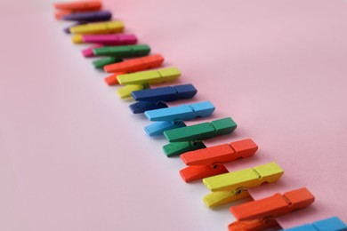 Many different colorful clothespins on pink background. Diversity concept Photo of Many different colorful clothespins on pink background. Diversity concept
