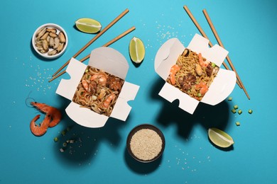 Boxes of wok noodles with seafood and chopsticks on turquoise background, flat lay Photo of Boxes of wok noodles with seafood and chopsticks on turquoise background, flat lay