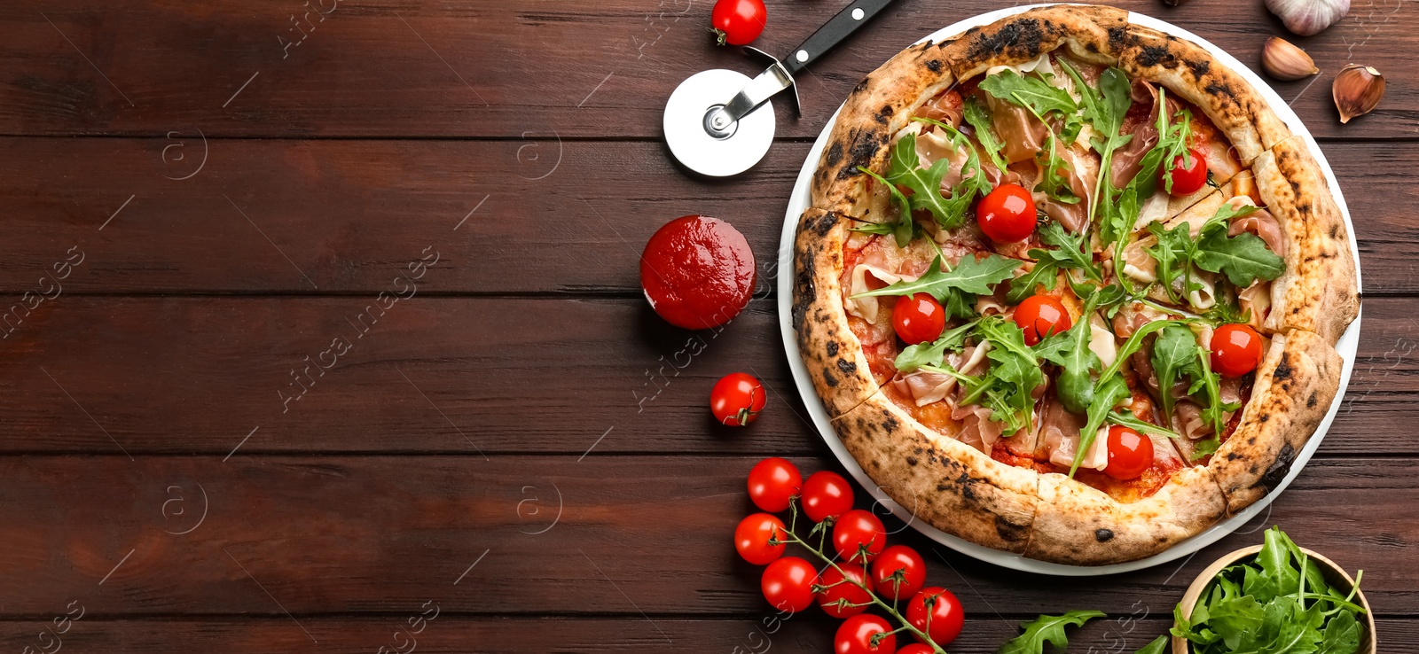 Tasty pizza with meat and arugula on wooden table, flat lay. Space for text Photo of Tasty pizza with meat and arugula on wooden table, flat lay. Space for text