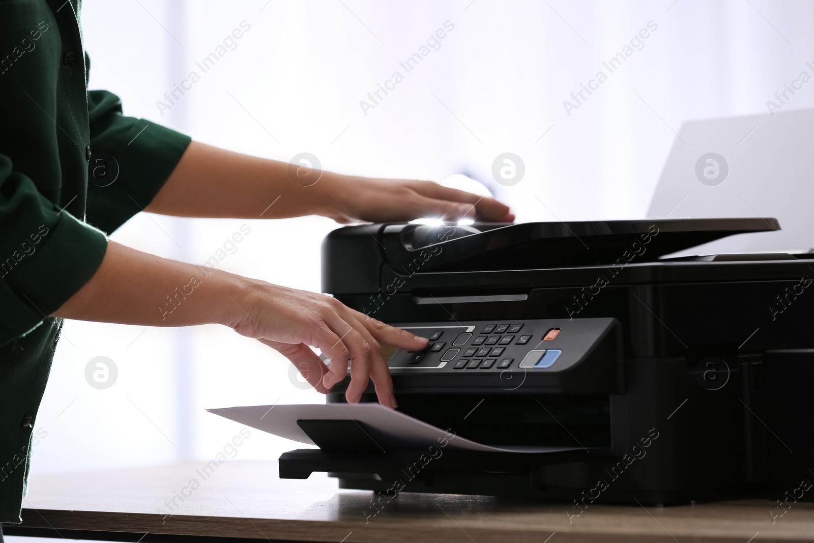 Employee using modern printer in office, closeup Photo of Employee using modern printer in office, closeup