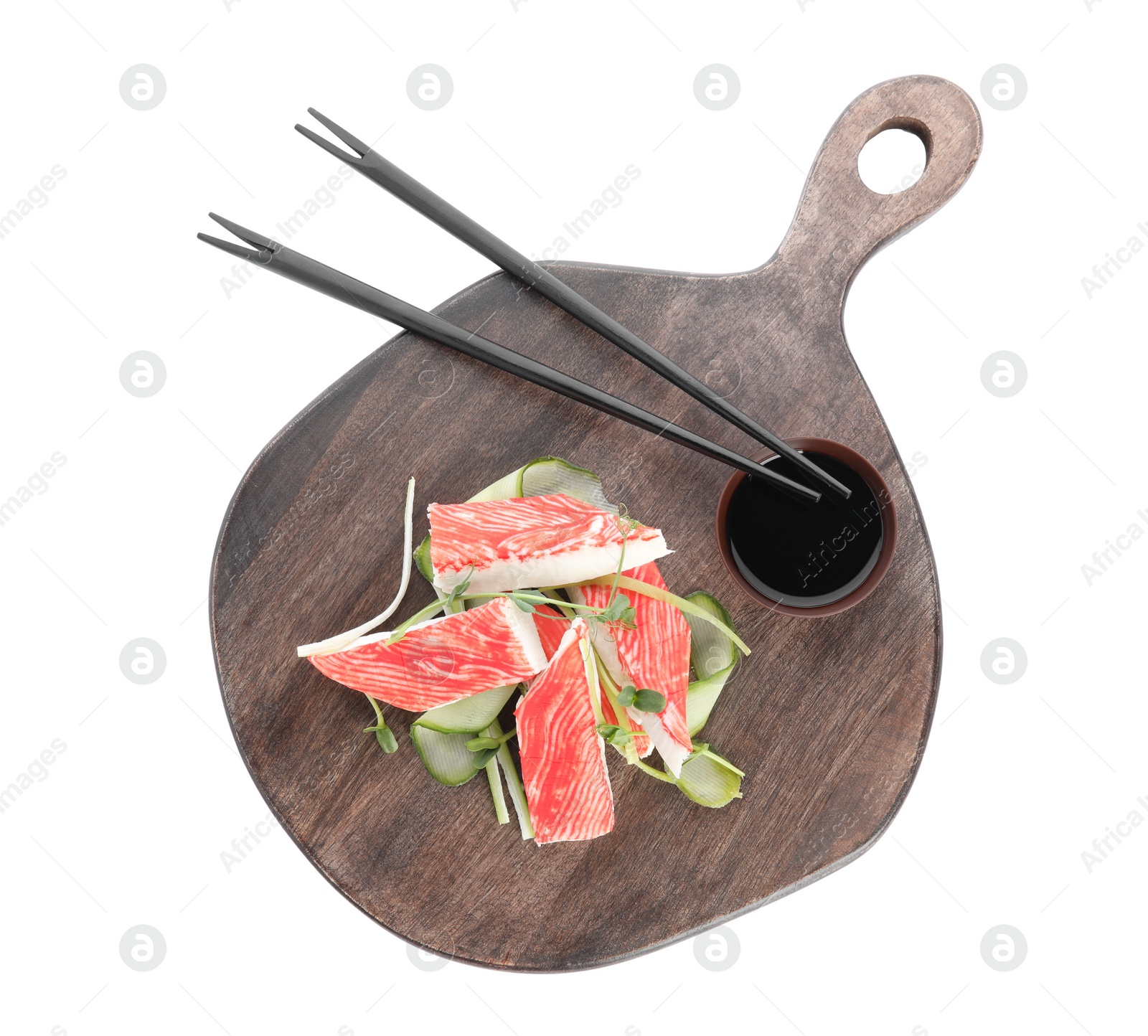 Serving board with fresh crab sticks, cucumber and soy sauce isolated on white Photo of Serving board with fresh crab sticks, cucumber and soy sauce isolated on white
