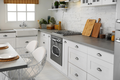 Beautiful kitchen interior with new stylish furniture Photo of Beautiful kitchen interior with new stylish furniture