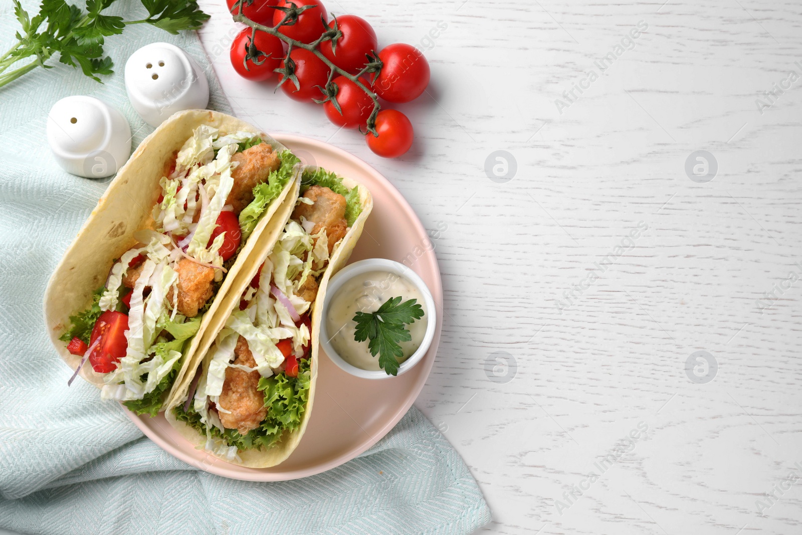 Yummy fish tacos served on white wooden table, flat lay. Space for text Photo of Yummy fish tacos served on white wooden table, flat lay. Space for text