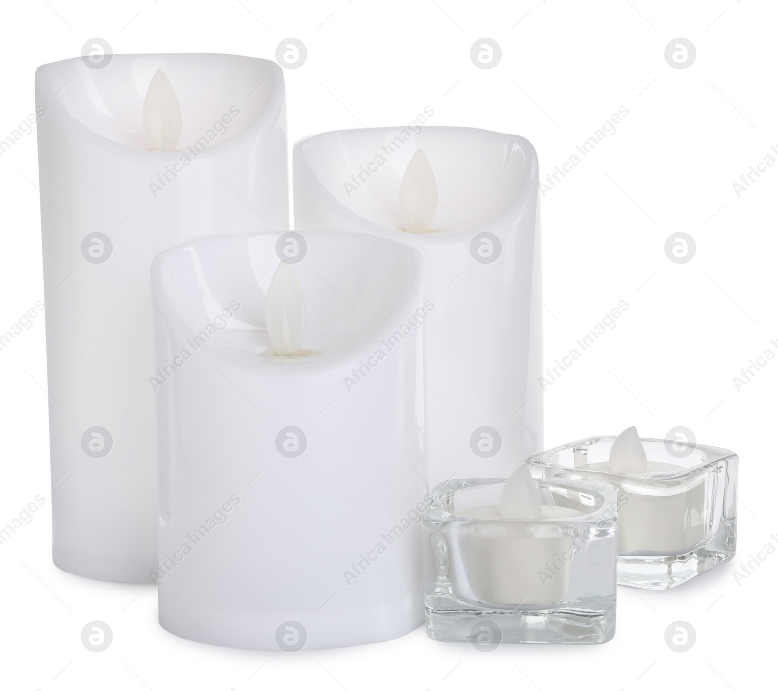 Different decorative flameless LED candles on white background Photo of Different decorative flameless LED candles on white background