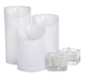Different decorative flameless LED candles on white background Photo of Different decorative flameless LED candles on white background