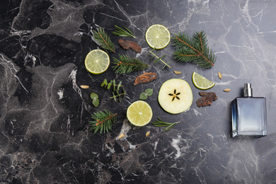 Photo of Flat lay composition with bottle of perfume on black marble background