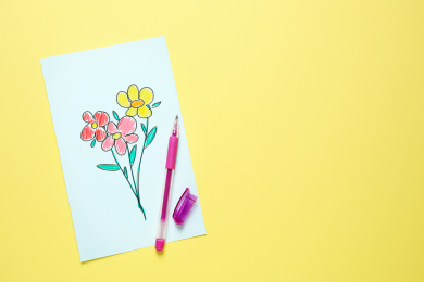 Top view of greeting card with drawn flowers and pen on yellow background, space for text. Happy Mother's day Photo of Top view of greeting card with drawn flowers and pen on yellow background, space for text. Happy Mother's day