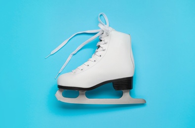Figure ice skate on light blue background, top view Photo of Figure ice skate on light blue background, top view
