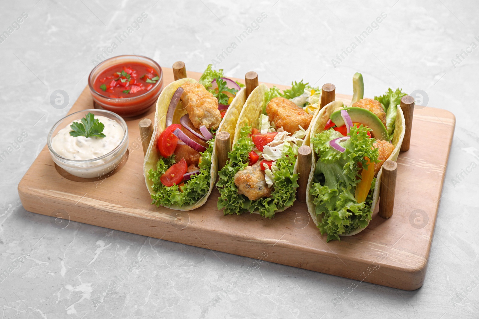 Delicious fish tacos served on grey marble table Photo of Delicious fish tacos served on grey marble table