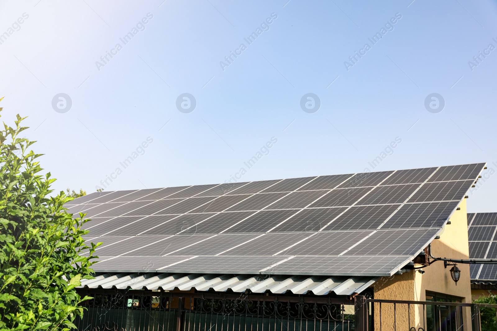 House with installed solar panels on roof. Alternative energy source Photo of House with installed solar panels on roof. Alternative energy source