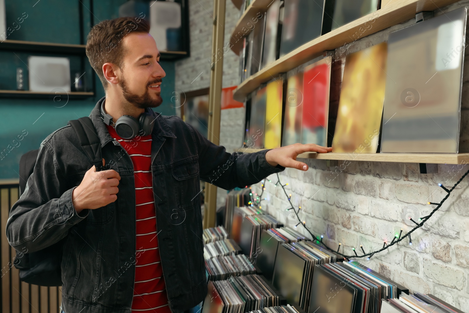 Young man choosing vinyl records in store Image of Young man choosing vinyl records in store