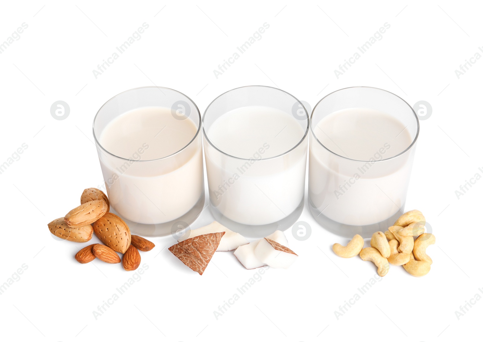 Vegan milk and different nuts on white background Photo of Vegan milk and different nuts on white background