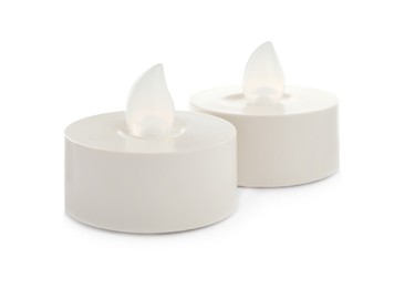 Decorative flameless LED candles on white background Photo of Decorative flameless LED candles on white background