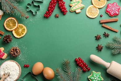 Frame of Christmas cookies, fir tree and flour on green background, flat lay. Space for text Photo of Frame of Christmas cookies, fir tree and flour on green background, flat lay. Space for text