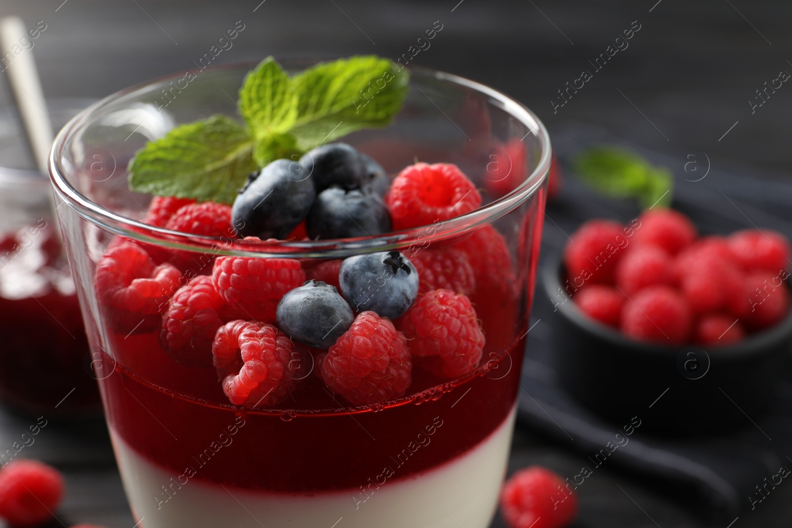 Delicious panna cotta with berries in glass dish, closeup Photo of Delicious panna cotta with berries in glass dish, closeup
