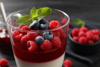 Delicious panna cotta with berries in glass dish, closeup Photo of Delicious panna cotta with berries in glass dish, closeup