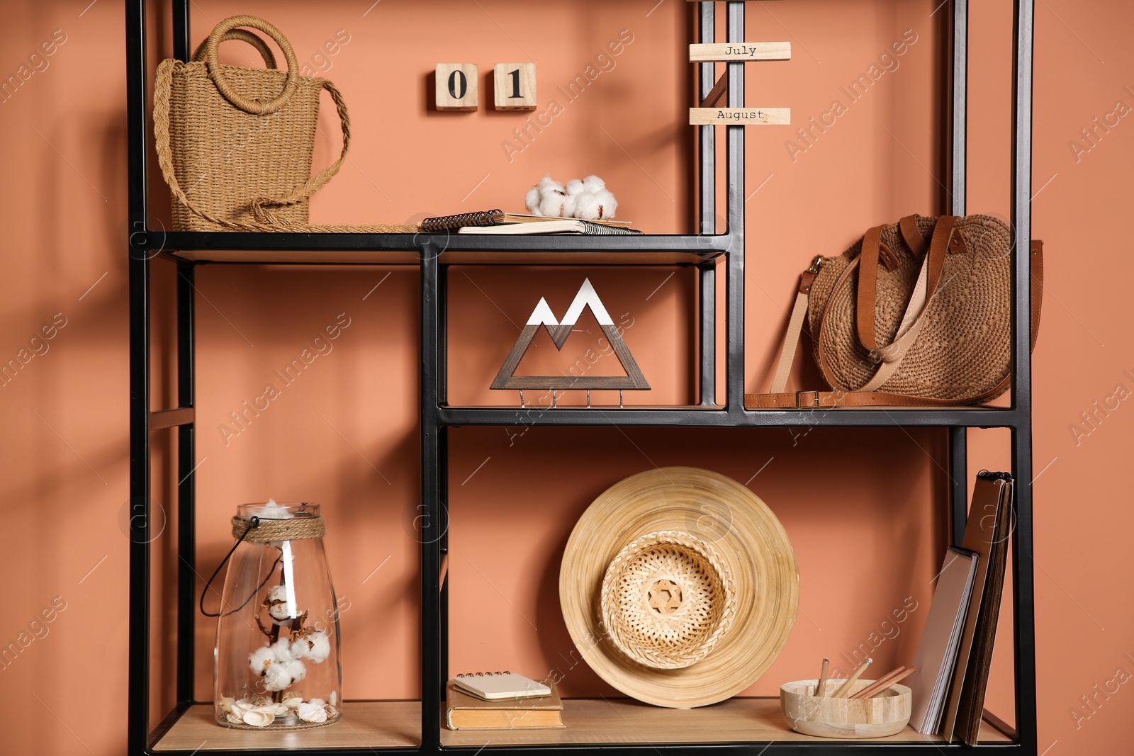 Stylish shelving unit with decorative elements near color wall. Interior design Photo of Stylish shelving unit with decorative elements near color wall. Interior design