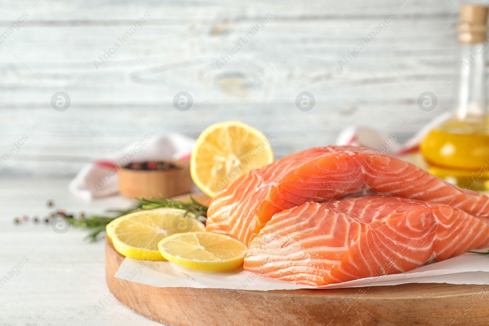 Fresh raw salmon with lemon on table. Fish delicacy Photo of Fresh raw salmon with lemon on table. Fish delicacy