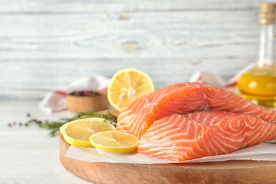 Fresh raw salmon with lemon on table. Fish delicacy Photo of Fresh raw salmon with lemon on table. Fish delicacy