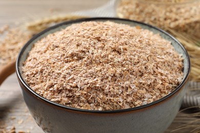 Dry wheat bran in bowl, closeup view Photo of Dry wheat bran in bowl, closeup view