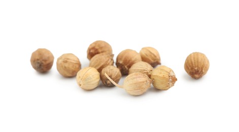 Photo of Scattered dried coriander seeds on white background, closeup