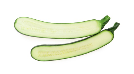 Halves of ripe zucchini on white background, top view Photo of Halves of ripe zucchini on white background, top view
